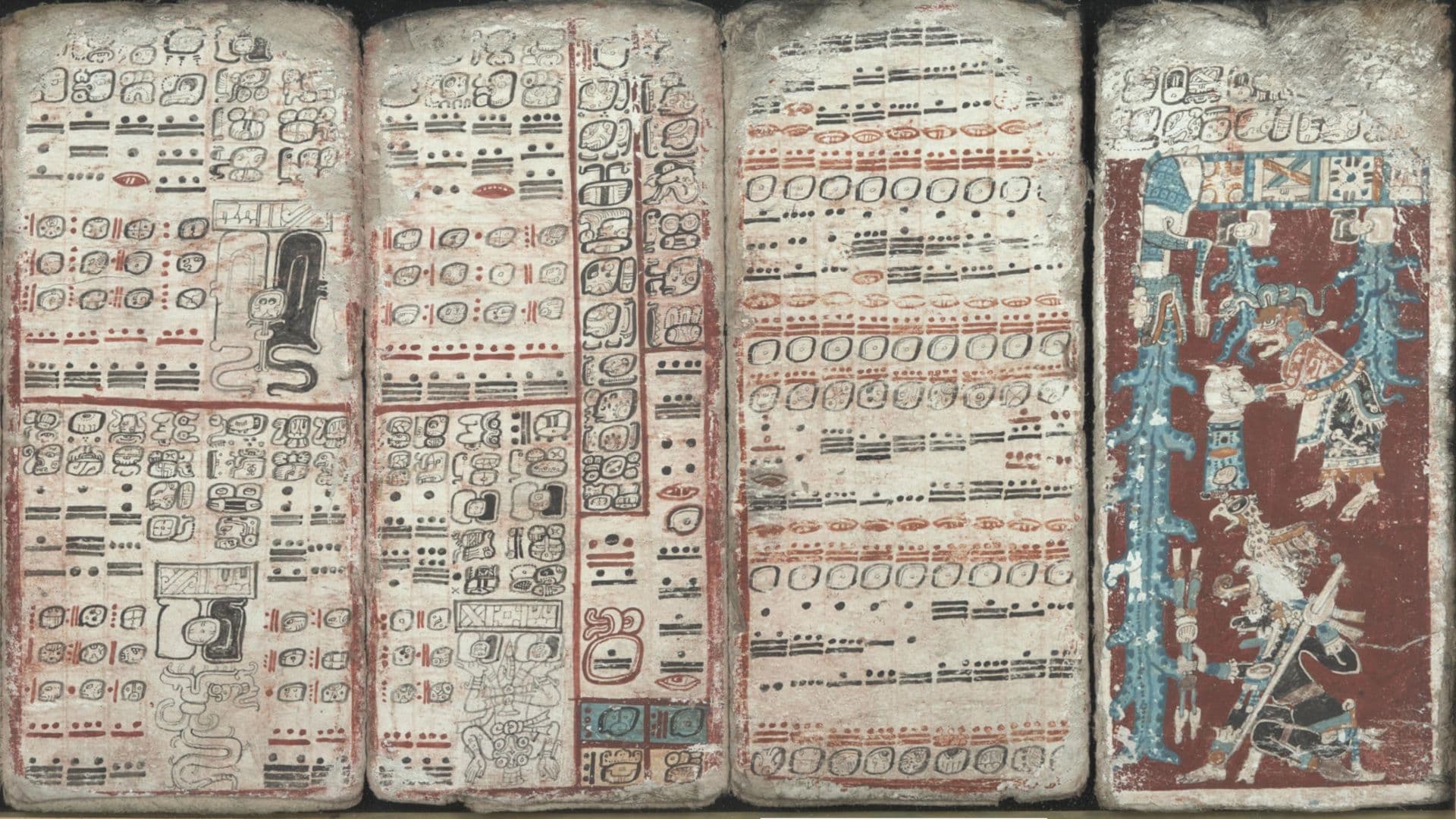 A portion of the Dresden Codex depicts Maya writing and illustrations in red, black, and turquoise.